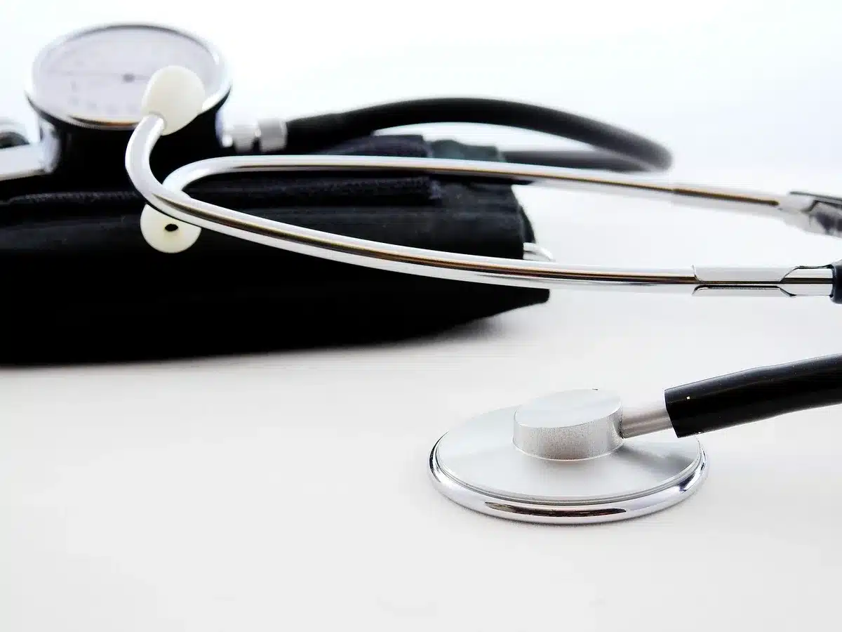 Médecin du travail observant un poste et documents médicaux anonymes