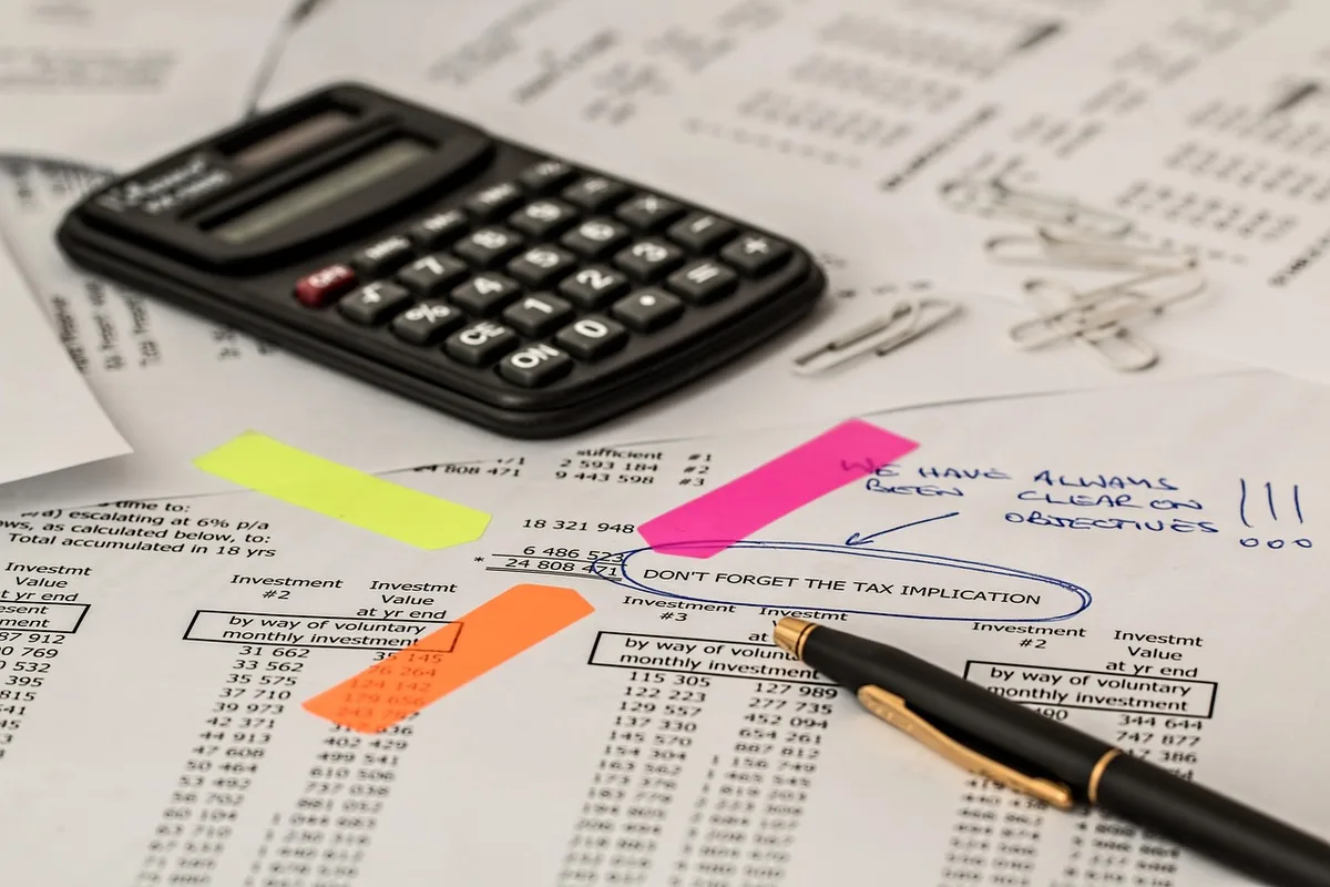Calculatrice, feuilles et ordinateur pour analyser la viabilité financière d'une franchise